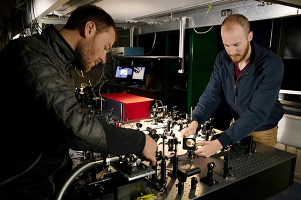 Doctoral students David Miller (left) and Andrew Blaikie work on an experiment in the Aleman Lab. They helped develop a device that measures light using one-atom-thin graphene sensors.